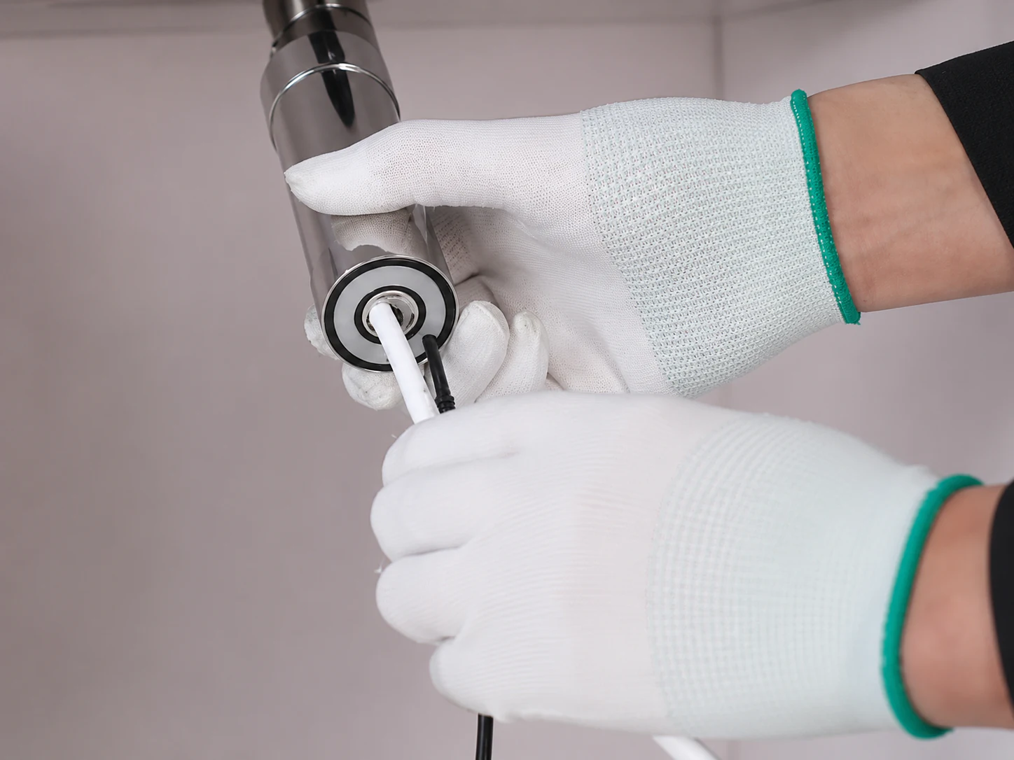 Technician inserting tubing into the quick-connect fitting of an AGLED-40002 UVC LED module